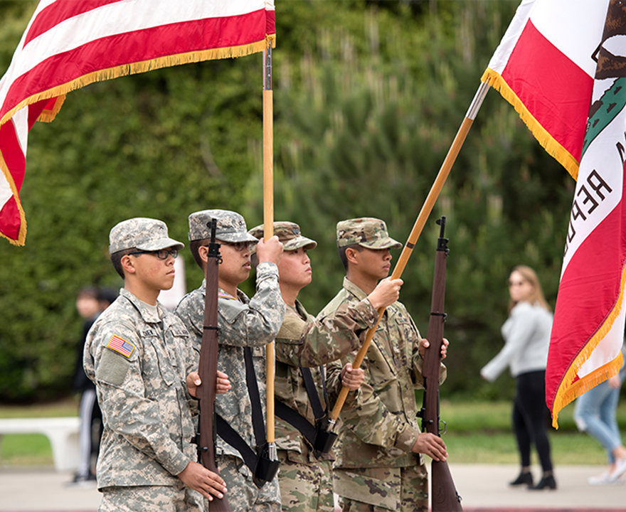 Soldiers holding the U.S. flag during memorial