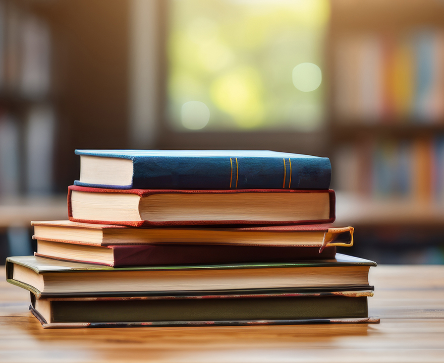 Set of books stacked on top of each other on a table